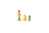 The image shows three wooden figurines with unique shapes and colors. The first figurine on the left is tall with a rounded top and has a yellow and natural wood color with green leaf patterns. The middle figurine is shorter and rounder, predominantly yellow with green leaf patterns. The third figurine on the right is the smallest, green in color, and shaped like a pawn from a chess set.