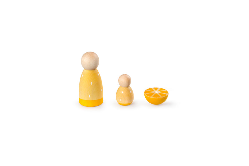 The image shows three wooden objects: two yellow cone-shaped figures with small black eyes and a floral design, and one orange half-sphere painted to resemble a slice. They are arranged in a row and are simple, colorful wooden toys for educational or decorative purposes.