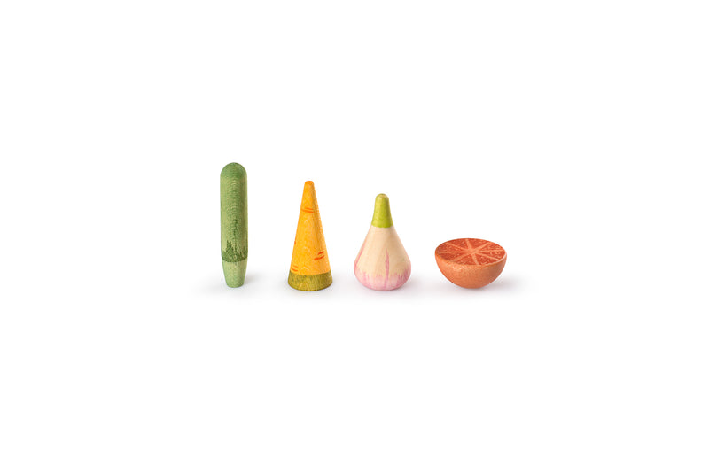 The image shows four wooden objects painted to resemble different vegetables and a fruit. From left to right, the objects are:

A green cylindrical object resembling a cucumber.

An orange conical object resembling a carrot.

A bulbous object with a green top and pinkish bottom resembling a radish or turnip.

A half-spherical object with an orange interior resembling a cut orange or grapefruit.

These objects are visually interesting due to their vibrant colors and stylized representations, likely intended 