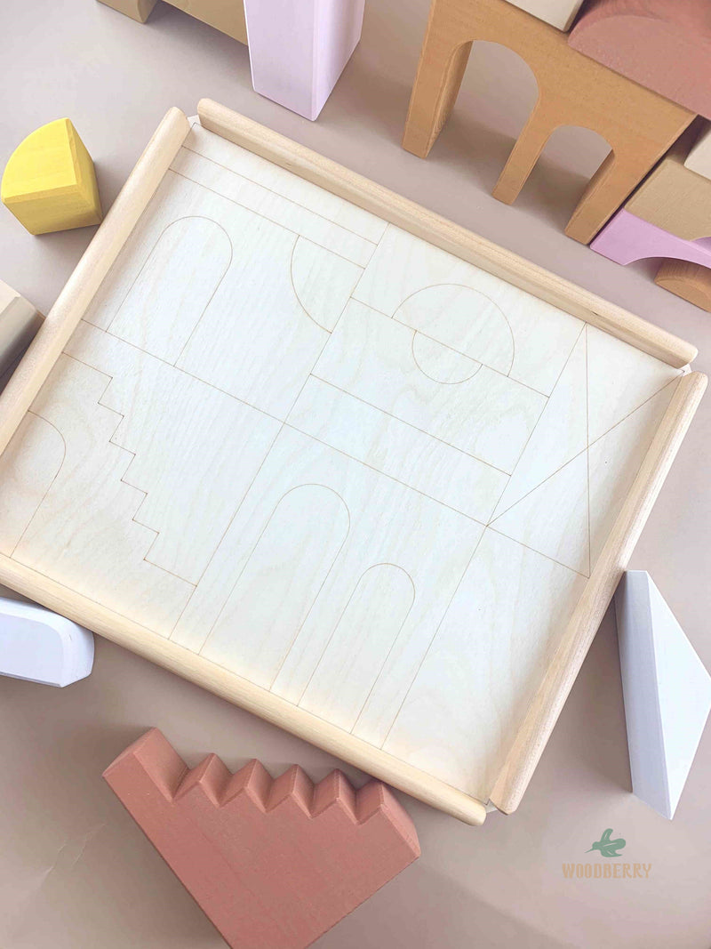 The empty wooden tray of Apartment blocks by Raduga Grez. The tray is etched with the shape of the blocks for easy cleanup and storage