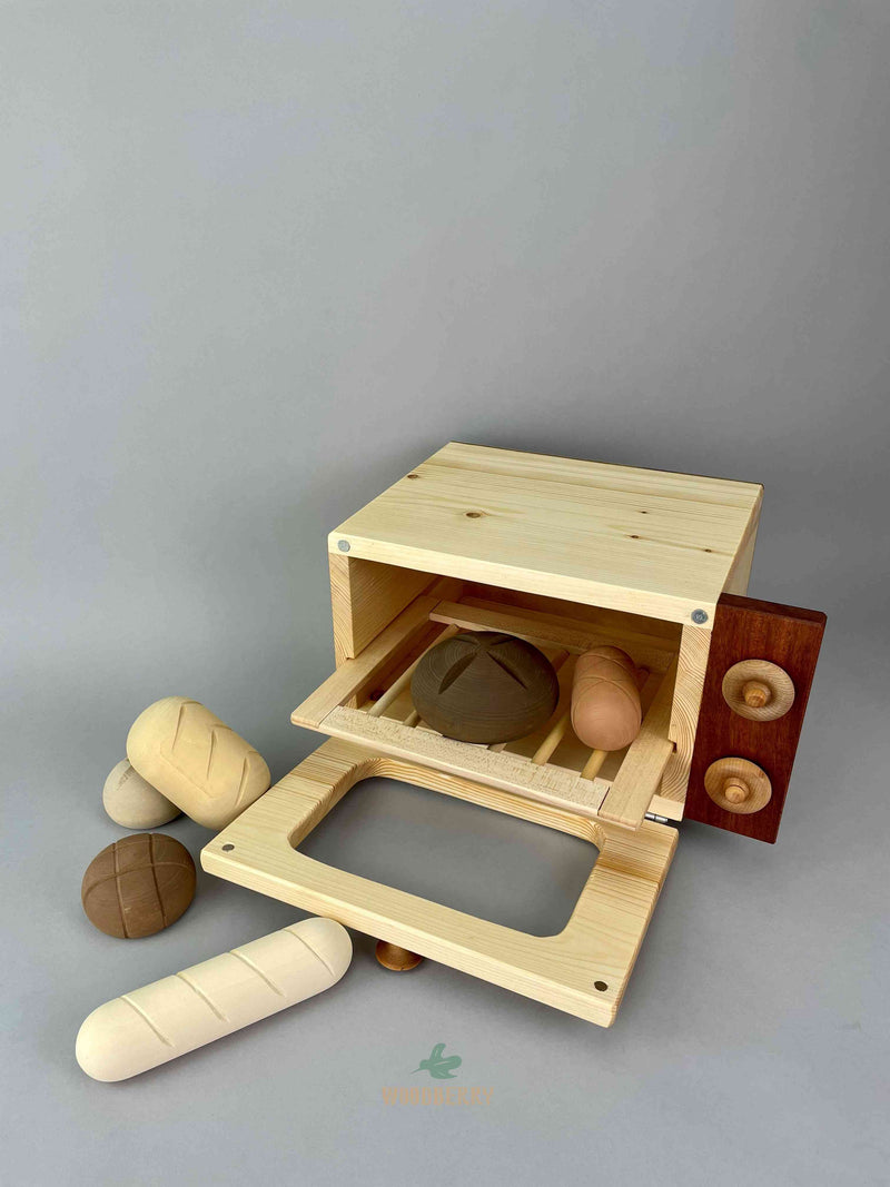 Hand made Wooden Toy toaster oven for pretend play.  Displayed with wooden bread by Raduga Grez. The rack of the oven is removable