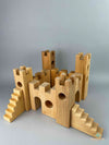 Woodberry Bauspiel Castle blocks arranged to form a castle including gates, towers, stairs and castle walls. 