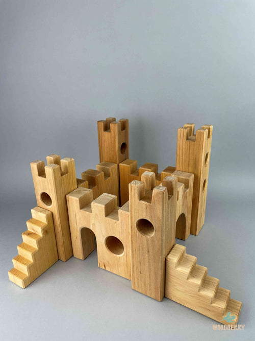 Woodberry Bauspiel Castle blocks arranged to form a castle including gates, towers, stairs and castle walls. 