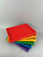 Woodberry Bauspiel set of 6 color rainbow trays stacked on top of each other and fanned out. 