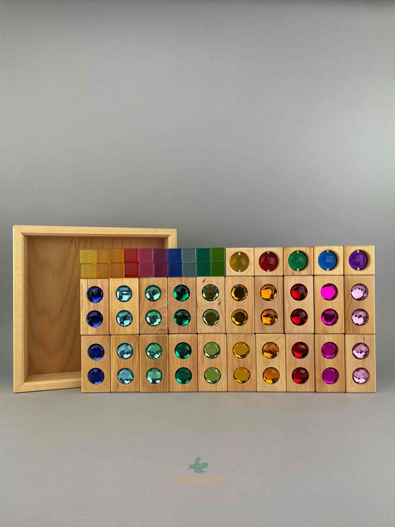 Full image of Bauspiel combination set standing upright. Includes 20 wooden colour street blocks, 20 acrylic lucent cubes, 5 gemmed window blocks and tray. 