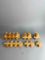 Image of plus block set from Bauspiel stacked and arranged in groups showing the different piece sizes. 