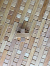 Top-down photo of one Single Plus block from Bauspiel on a bed of plus blocks arranged to form a flat surface. 