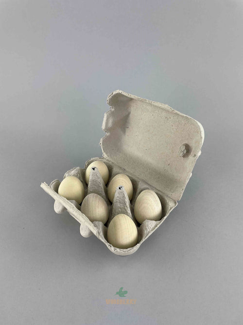 Carton of six wooden eggs in white from Erzi. Displayed with carton open. 