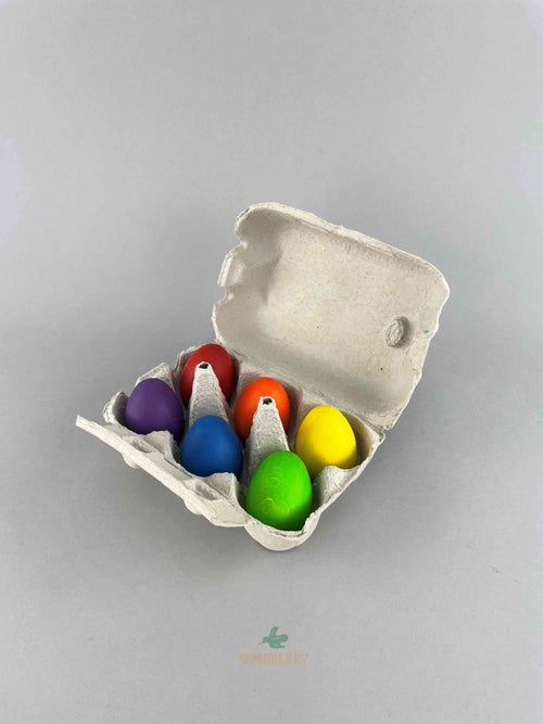Carton of six rainbow colored wooden eggs from Erzi. Displayed with carton open. 