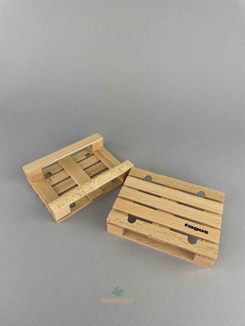 Two wooden pallets toy by Fagus wooden vehicles. One at the front. The other one is upside down to show the back of the pallet