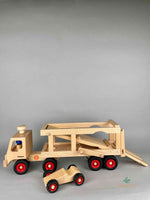 Woodberry Fagus Car Transporter shown with bed lowered. Two peg people sit in the truck and a racer car. 