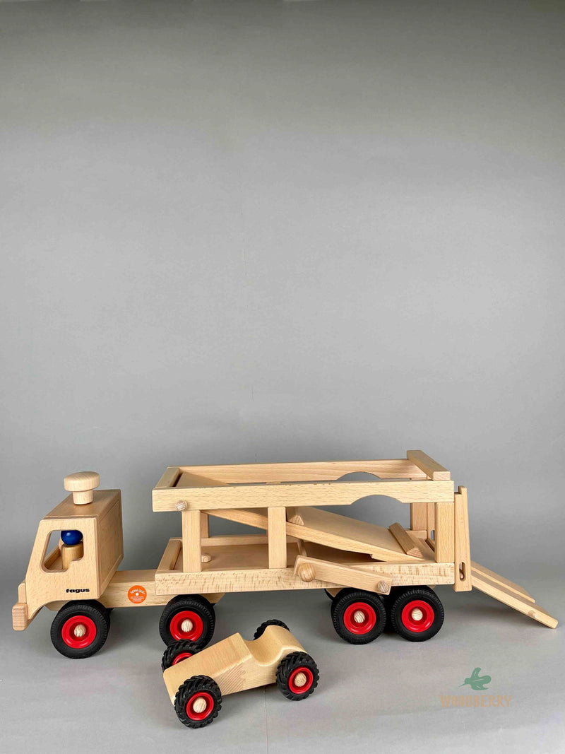 Woodberry Fagus Car Transporter shown with bed lowered. Two peg people sit in the truck and a racer car. 