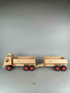 Woodberry Fagus Container Tipper truck side view image of truck with additional dump trailer attachment shown hitched on the rear. 