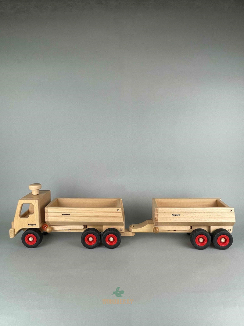 Woodberry Fagus Container Tipper truck side view image of truck with additional dump trailer attachment shown hitched on the rear. 