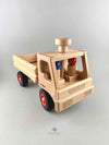 Woodberry Fagus Dump truck wooden toy front angle view with two peg people sitting in the truck cab. 