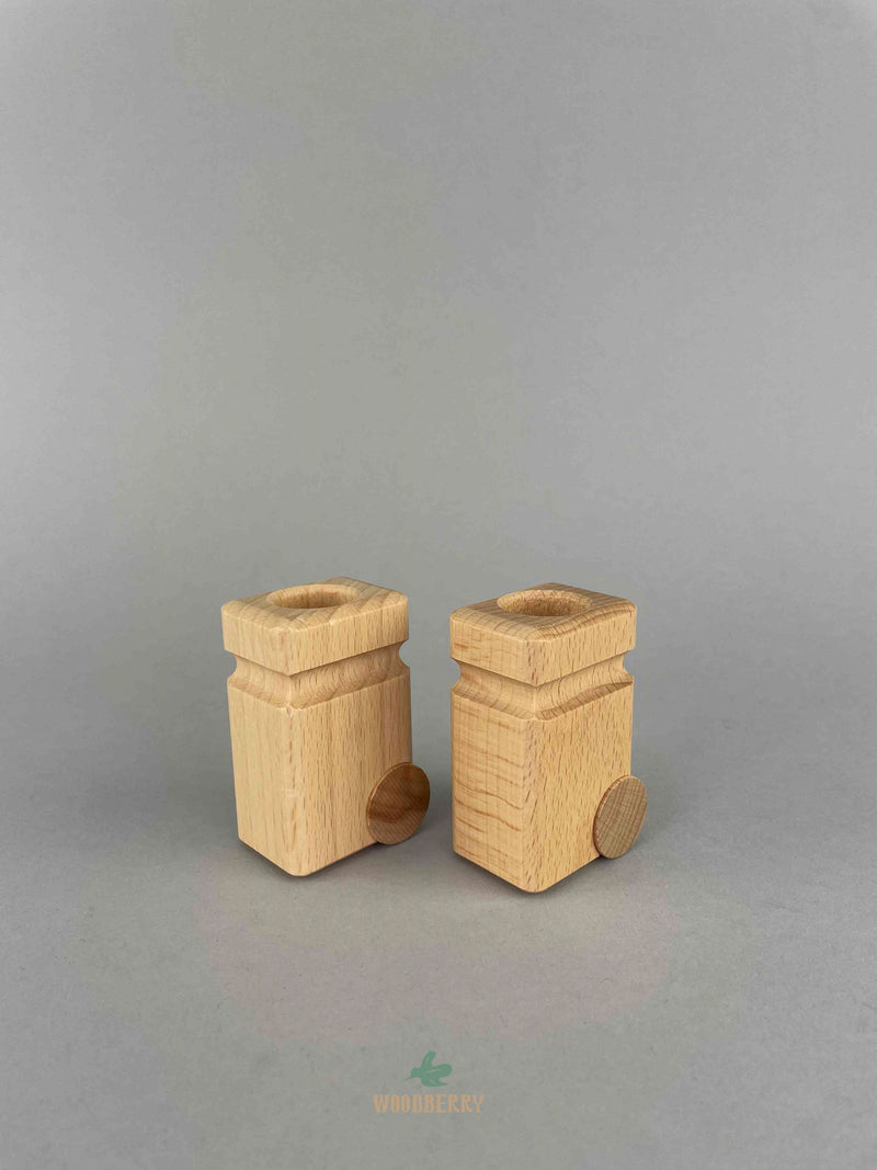 Two natural color Fagus wooden garbage cans side by side at an angle with the wheels at the back.