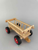 The back view of the Fagus wooden trucks Hay Wagon to see the back hitch. The Hay Wagon is empty with four rubber tires. 