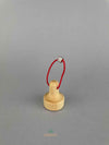 A wooden lifting magnet with red loop hanging rope by Fagus toy. 