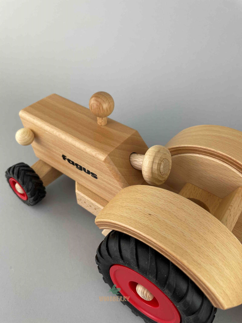 Top-side view of the Fagus wooden old-fashioned tractor. The steering wheel is steerable