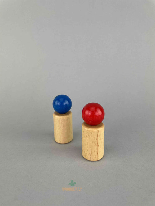 Two wooden peg doll toy - one red at the front and one blue at the back. .