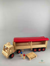 Woodberry Fagus Semi-Truck and Trailer wooden toy, including two peg people and a wooden Euro Pallet. Tarpaulin cover of trailer is folded up to reveal inside the trailer.