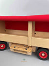 Woodberry Fagus Semi-Truck and Trailer side view picture of trailer with tarpaulin cover raised to show inside trailer. Euro pallet shown to be stored beneath trailer in storage compartment.