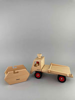 Woodberry Fagus Skip Truck side view with cargo container resting on ground in front of truck. 