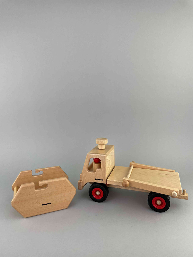 Woodberry Fagus Skip Truck side view with cargo container resting on ground in front of truck. 