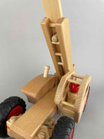 Woodberry Fagus Telescopic Loader with an inner angle view of raised boom. One peg person sits in the control seat.