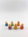 Wooden baby nins by Grapat standing in two rows. Front row left to right : purple, yellow, red. Back row left to right : blue, green, orange