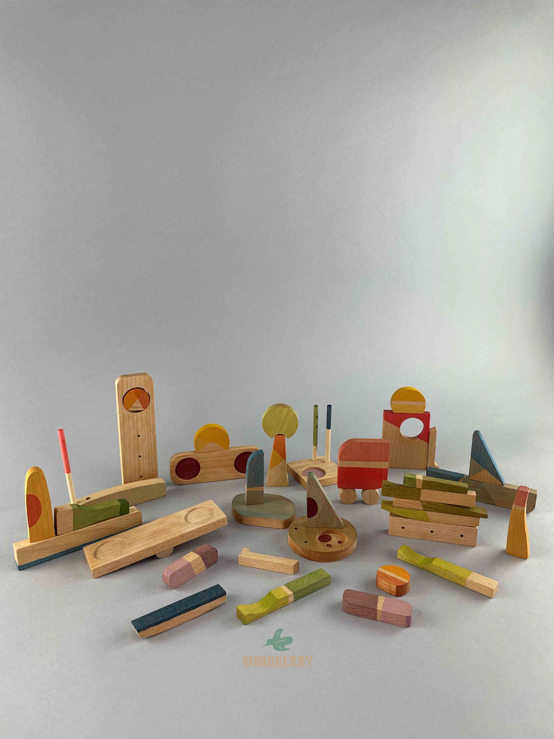 Set of Grapat 2023 Happy Place wooden blocks placed in miscellaneous positions resembling buildings and vehicles.