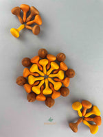 Grapat 2023 Pumpkin mandala pieces arranged in a circular patter, surrounded by two tree patterns.
