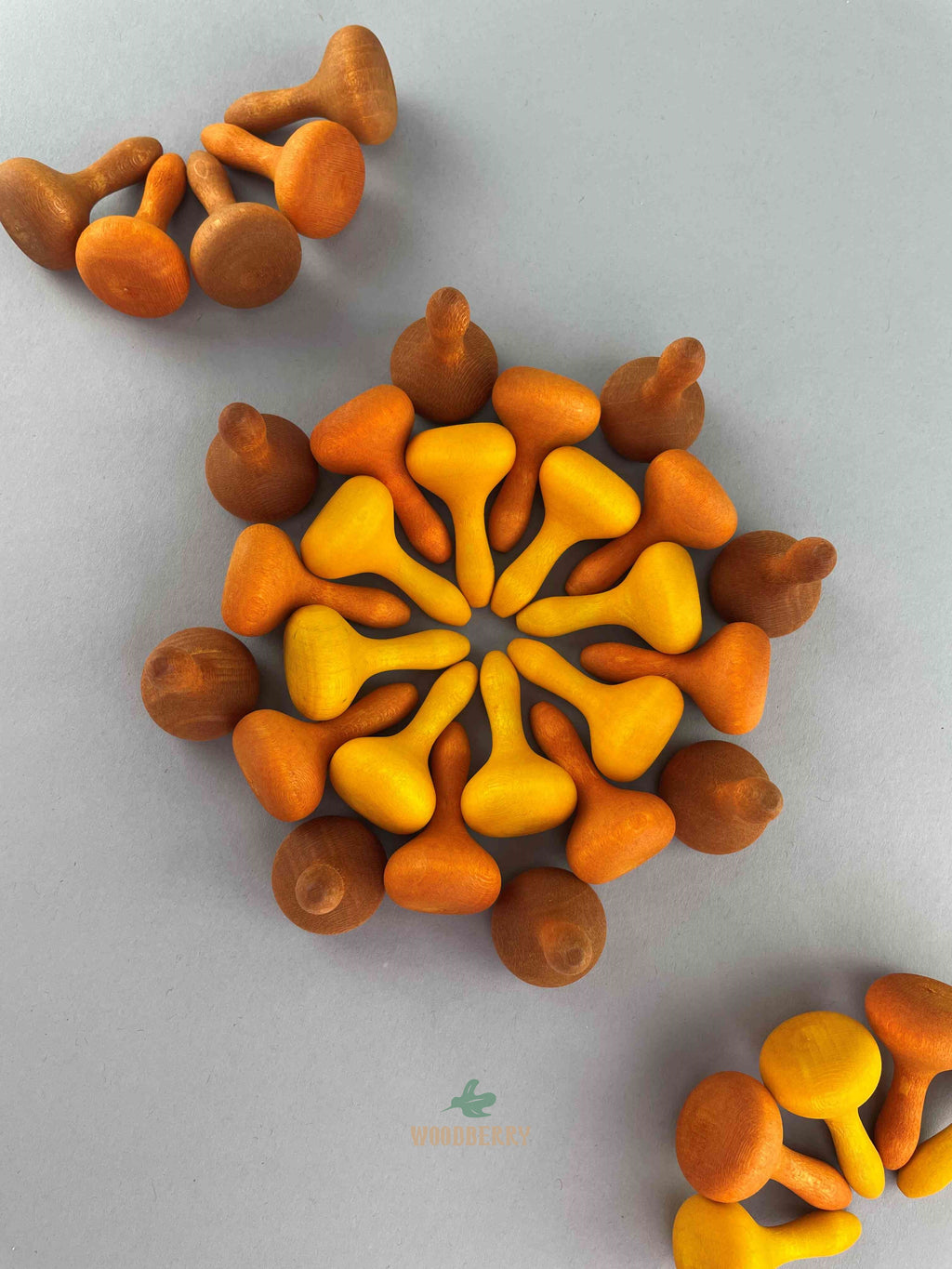 Hand-painted wooden mandala pieces in various shapes, including pumpkins, on a grey background.