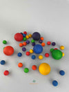 Random colorful assortment of 6 large wooden balls with a mix of smaller wooden marbles by Grapat. 