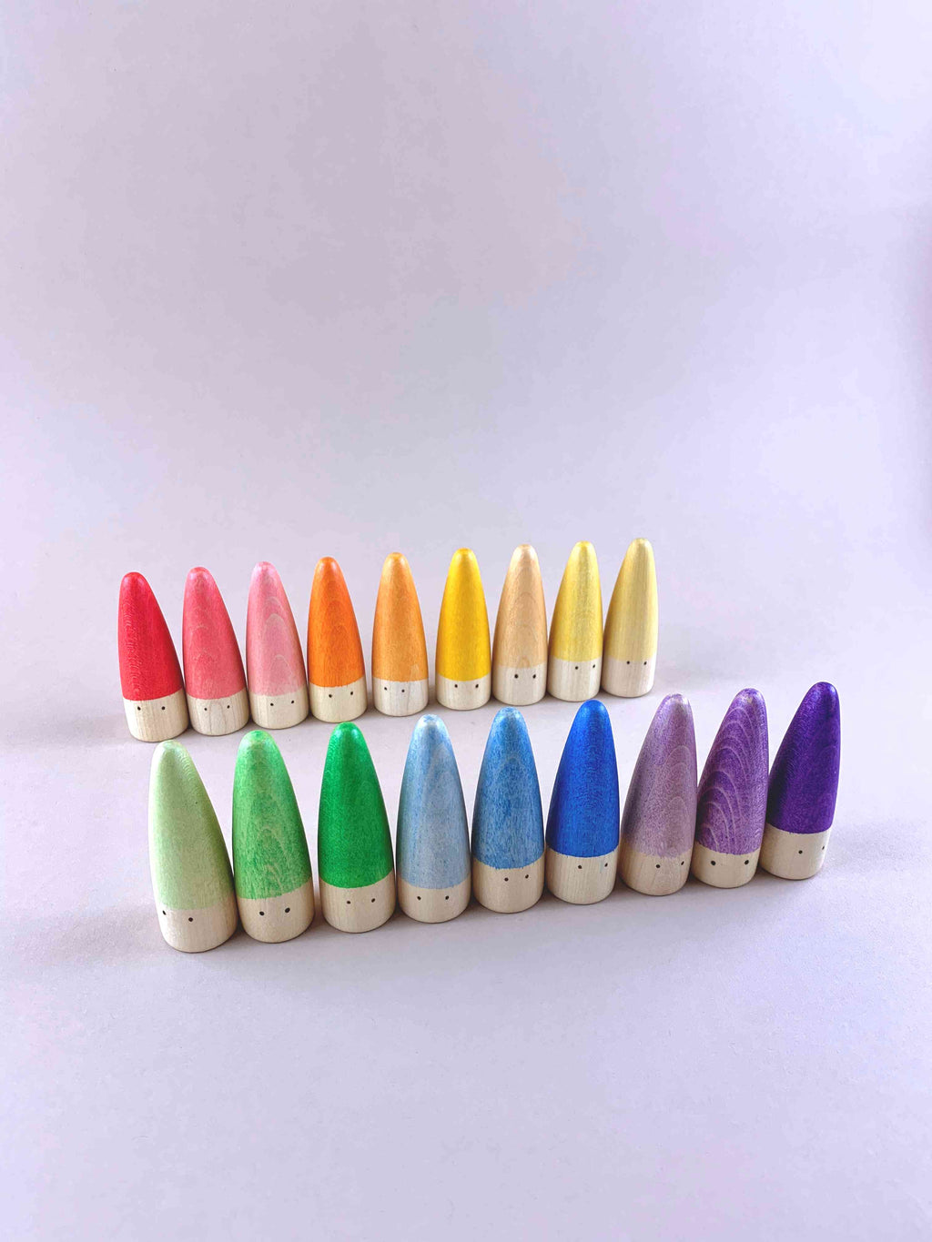 18 Grapat Stickes arranged standing in a circular pattern in rainbow order