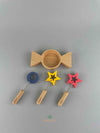 Woodberry Kiko gg wooden candy-shaped bubble dish with two star-shaped wands and one circular wand. Arranged to show all pieces.
