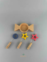 Woodberry Kiko gg wooden candy-shaped bubble dish with two star-shaped wands and one circular wand. Arranged to show all pieces.