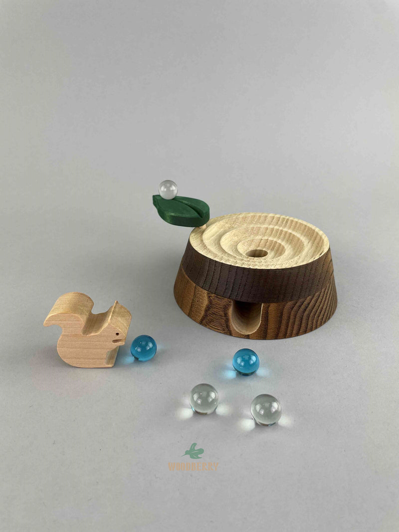 Woodberry Oak Village marble run tree stump with glass marbles and wooden squirrel figure. 