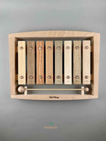 Wooden toy 8 key xylophone. Top view. Each key is made of a different wood species and engraved with the name of the wood in Japanese   