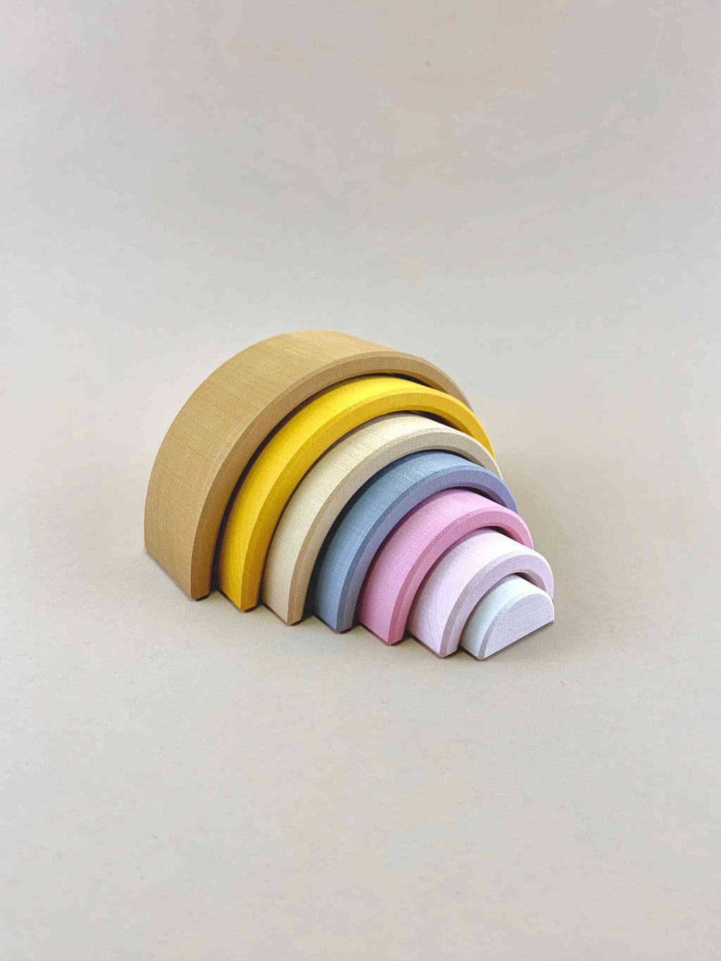Raduga Grez Rainbow small stacker in sand. 7 pcs total. Light brown-mustard yellow- beige- powder blue- pink- light pink- white