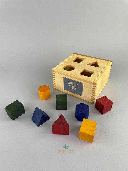 eight wooden blocks in the shape of cube, rectangle, triangle and circle in four colors - red, yellow, green and blue. With one removable-lid sorting wooden box for sorting game. Wooden Toys made by Wooden Story